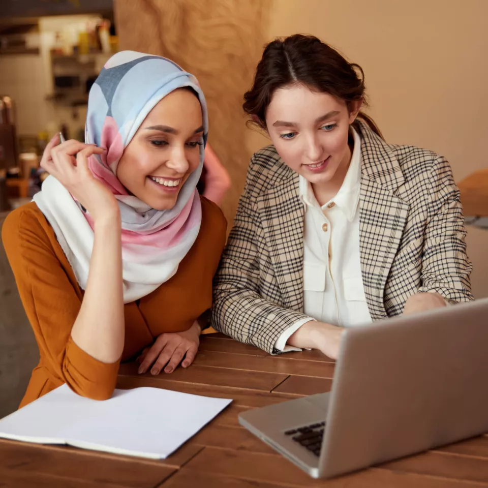 Young women working in front of the pc