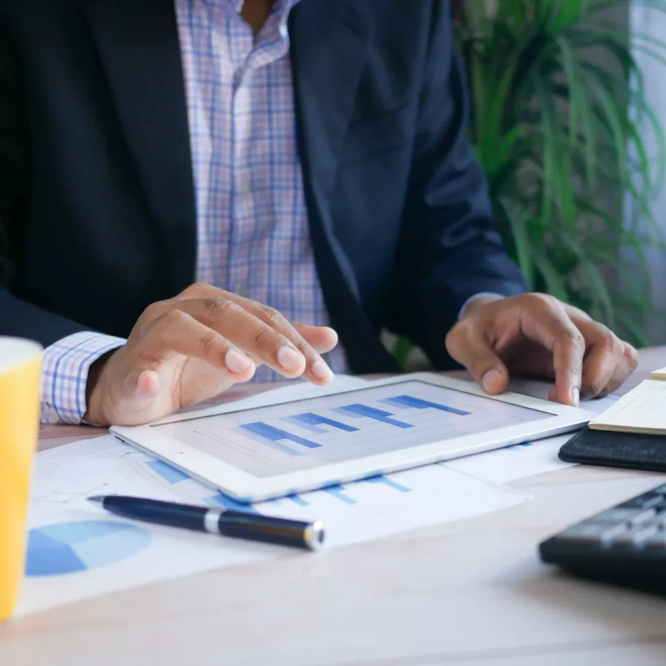 Man working in his office with the tablet