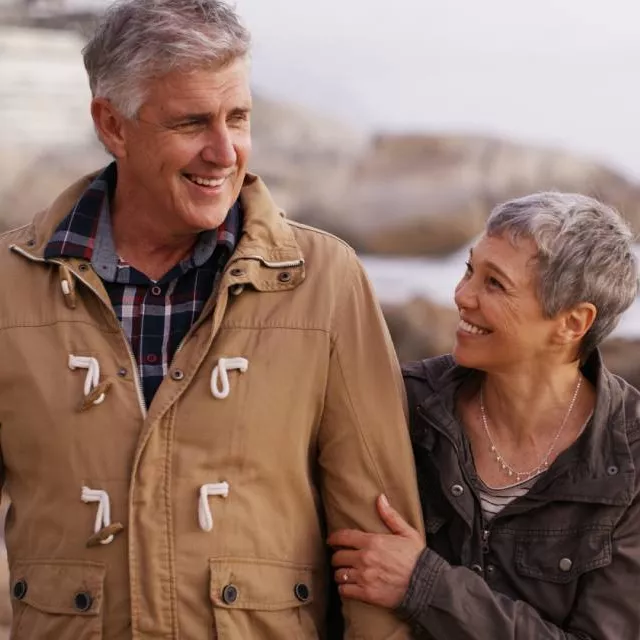Man and woman smiling near the sea