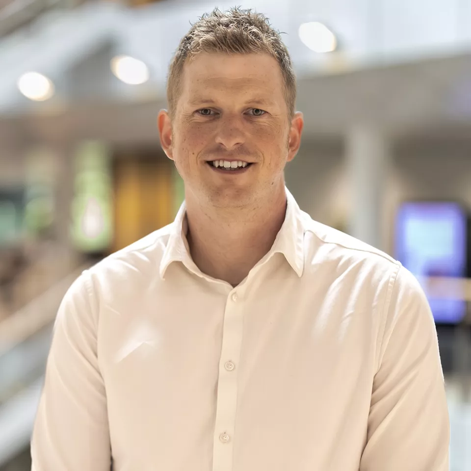 Man on the upper atrium floor in the Greenford office 