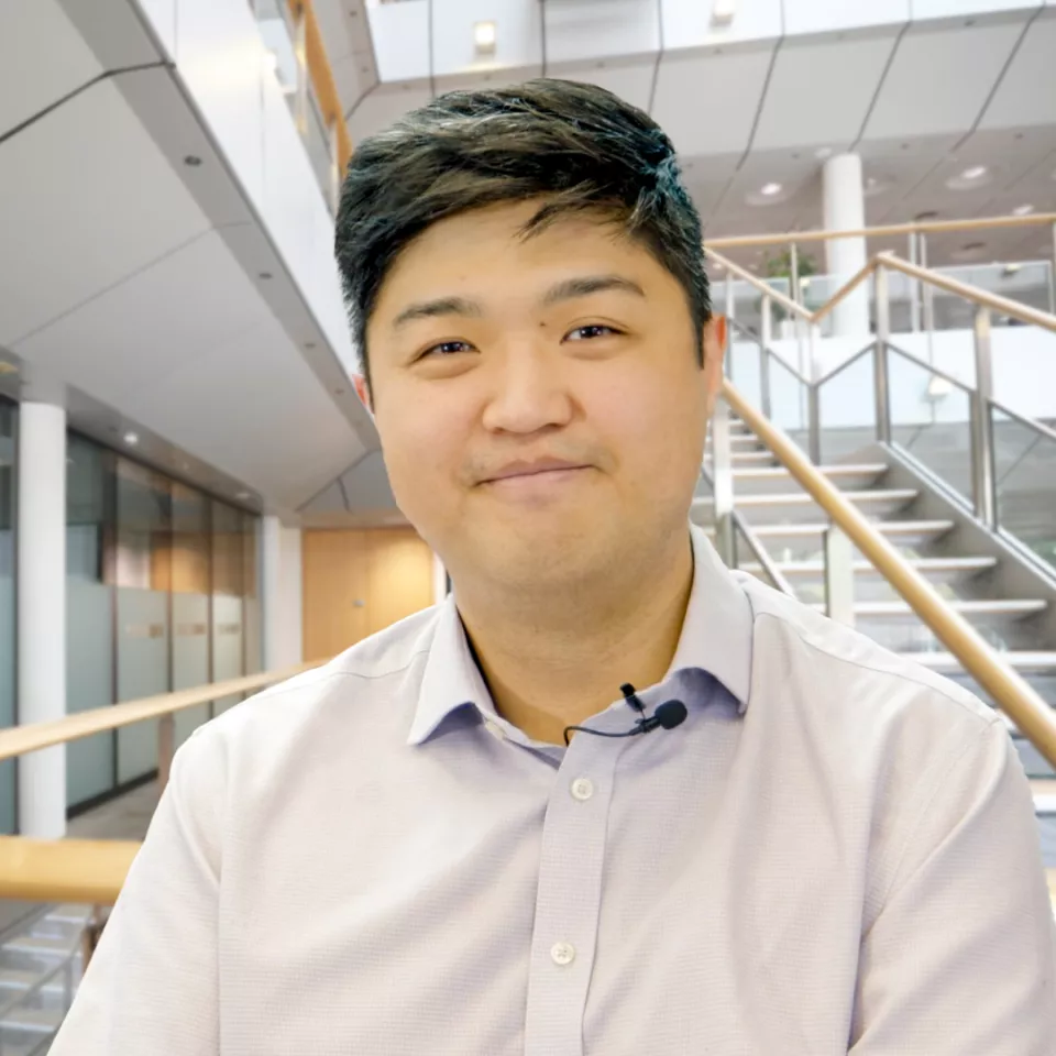 Man on a upper walkway in the Greenford office 