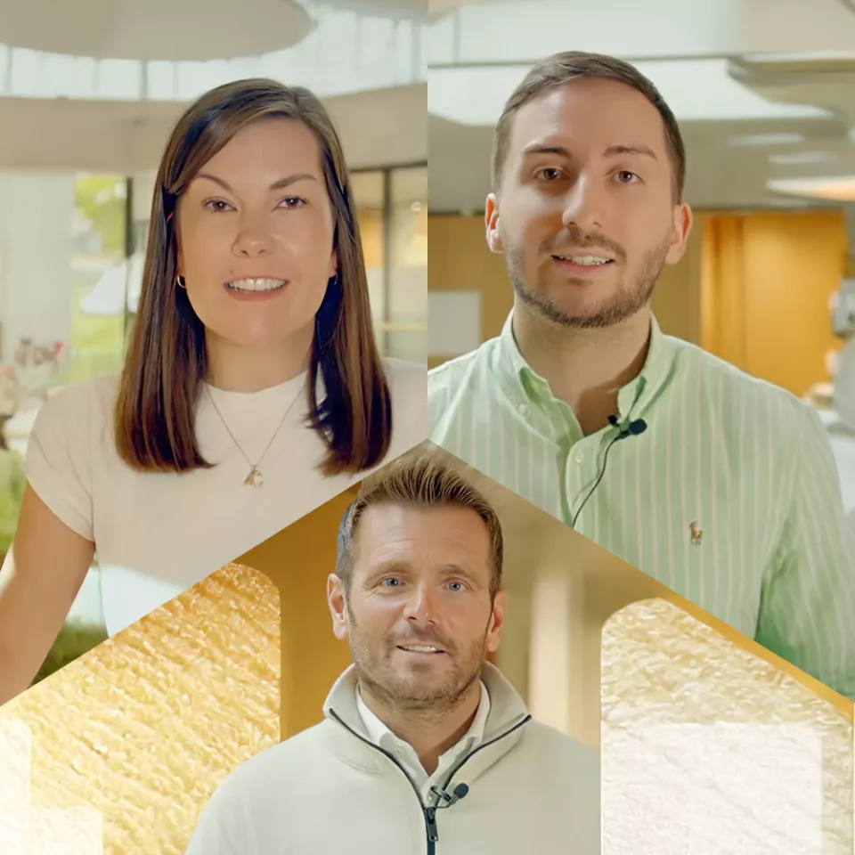 3 people, a famale and 2 males smiling 