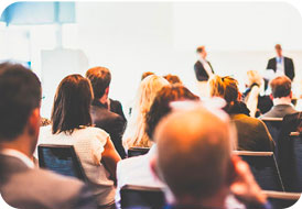 Audience listening to presenters at a business conference or seminar