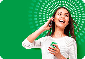 Young woman smiling while holding a Tic Tac box and listening to earbuds