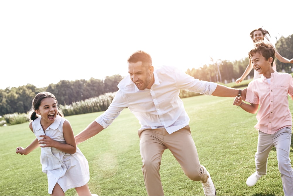 Man, woman and two children racing