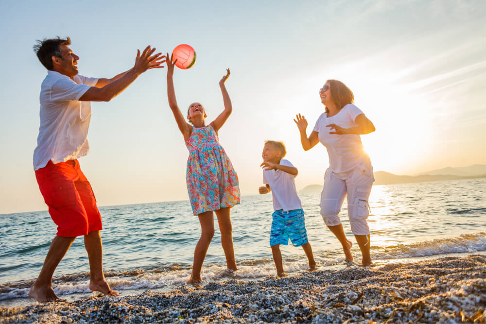Family playing the game at the seaside