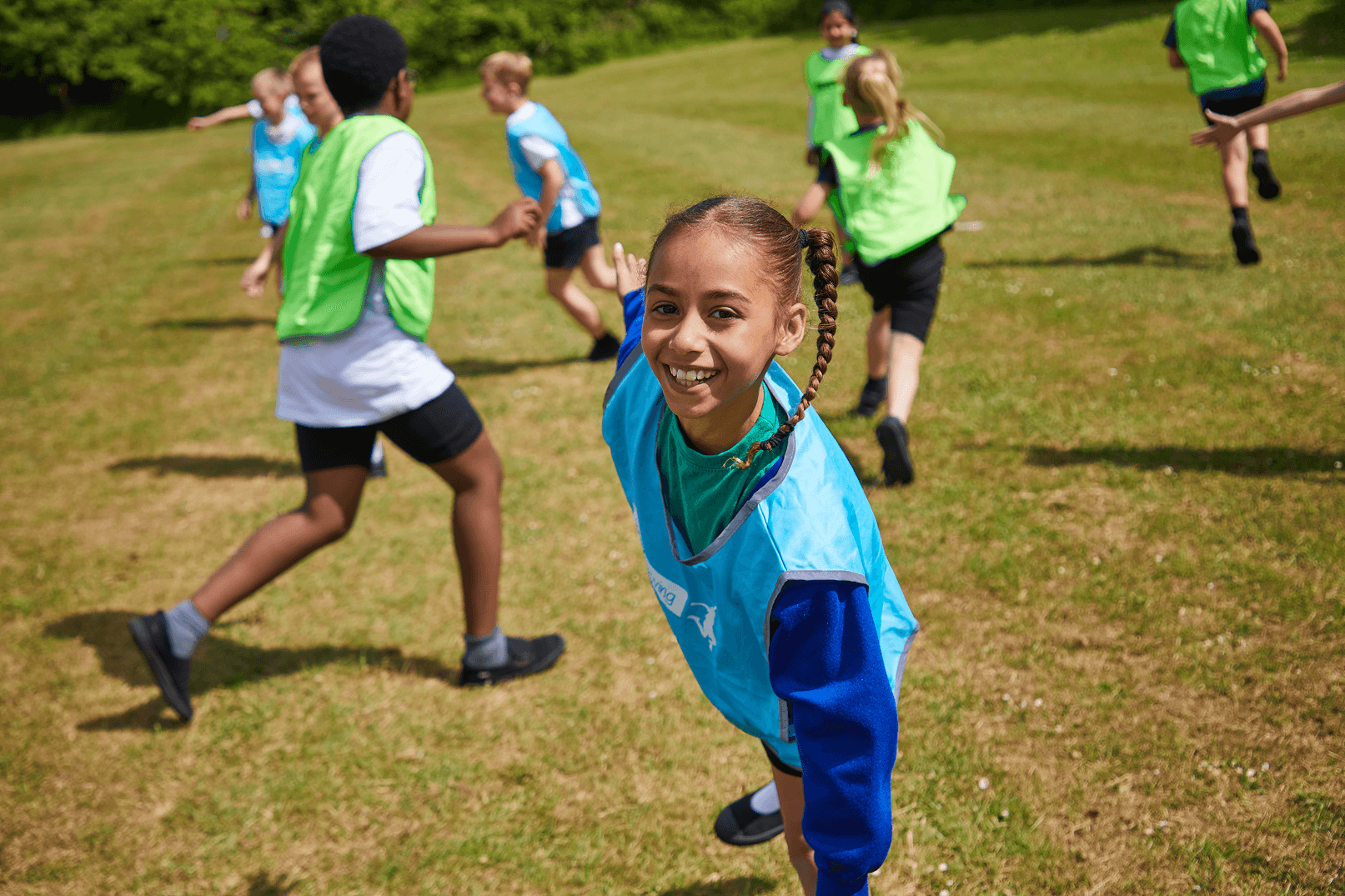Group of children in sports bibs smiling