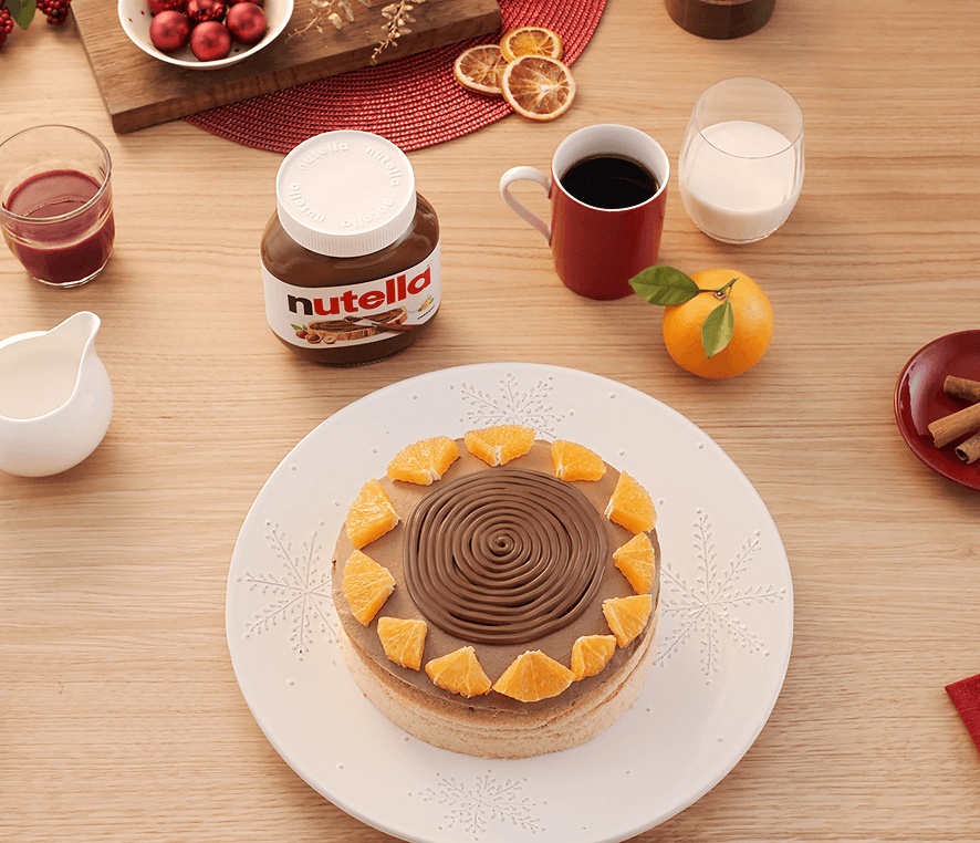 Gluten-free orange cake topped with a swirl of Nutella and orange segments