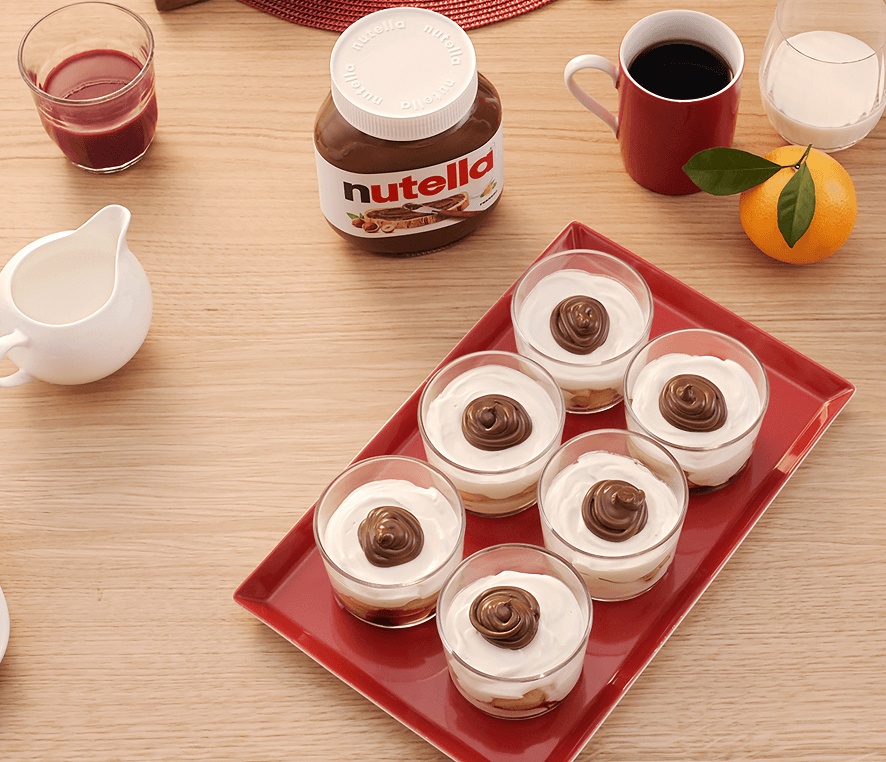 Individual cups of Christmas Tiramisu dessert layered with Nutella and cream