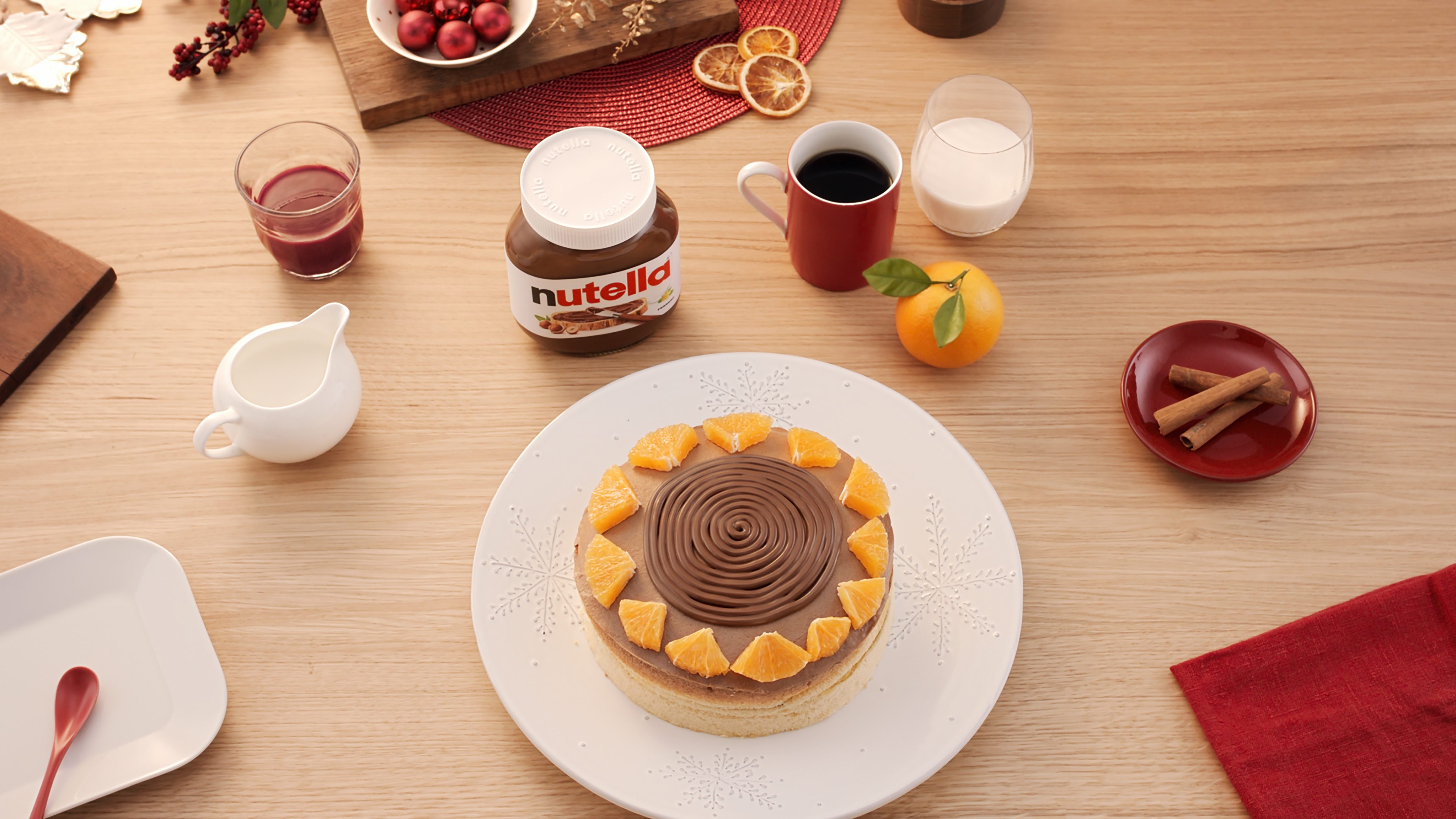 Gluten-free orange cake topped with a swirl of Nutella and orange segments