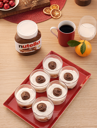 Individual cups of Christmas Tiramisu dessert layered with Nutella and cream