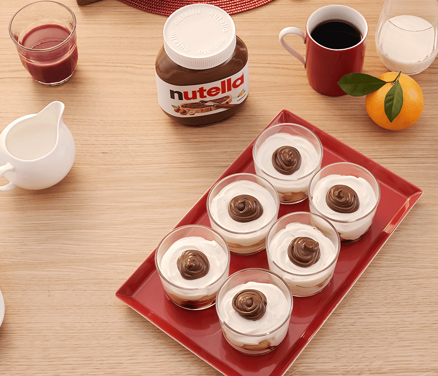 Individual cups of Christmas Tiramisu dessert layered with Nutella and cream