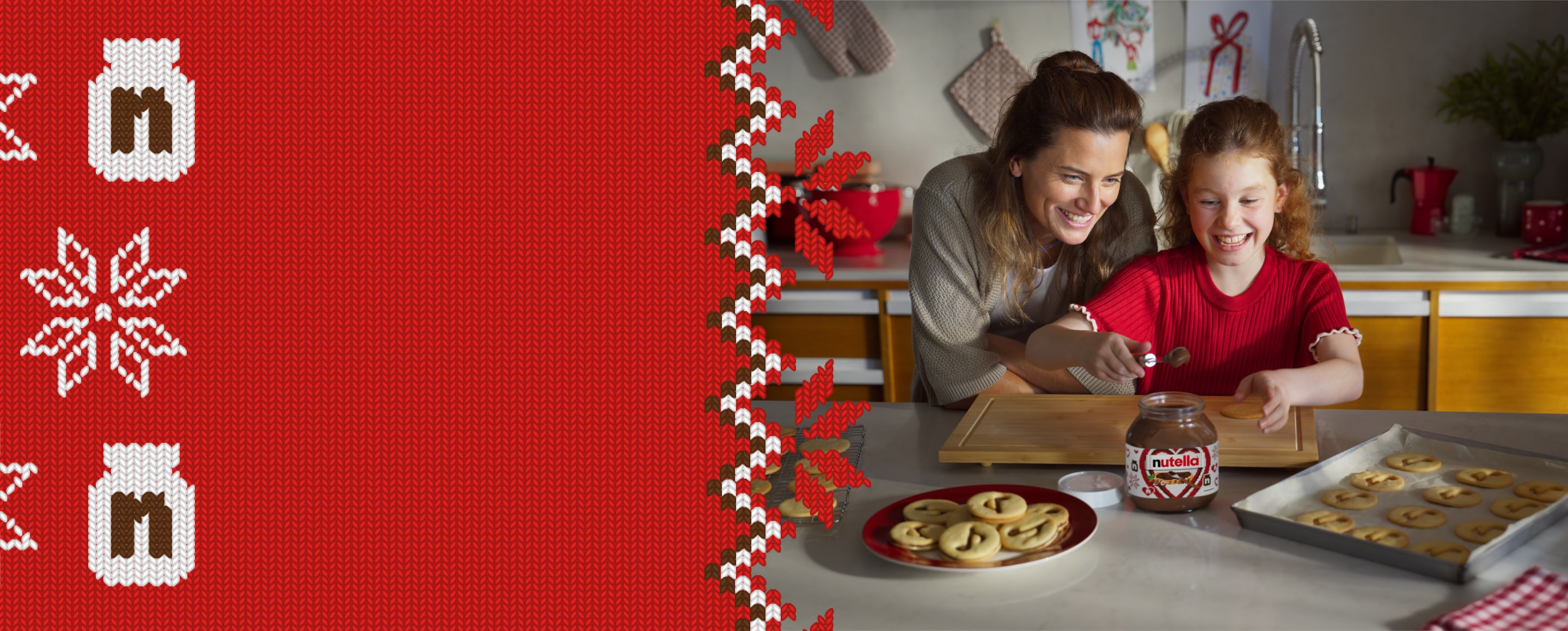 A young girl is using a spoon to scoop Nutella® out of a jar to decorate Nutella® biscuits, while her mother watches over her shoulder.