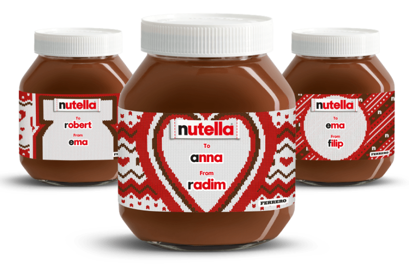 Three Nutella® knitted-labelled jars in a diagonal line, receding into the background on a festive red knitted style background.