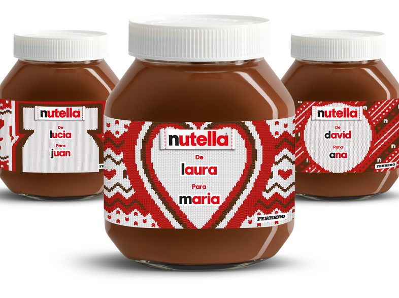 Three Nutella® knitted-labelled jars in a diagonal line, receding into the background on a festive red knitted style background.